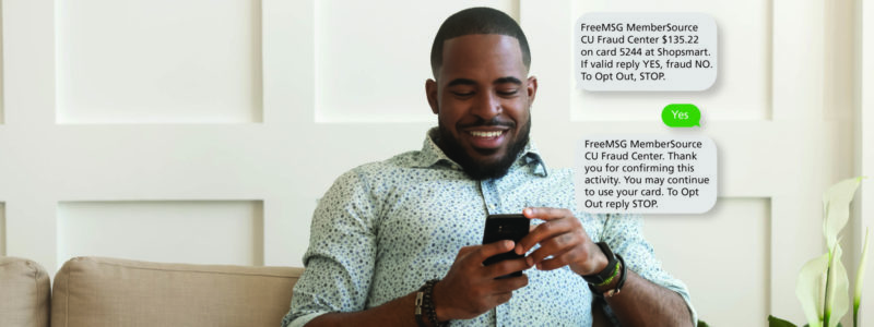 african american male looking at cell phone with text message